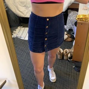 Blue cord mini skirt with gold poppers